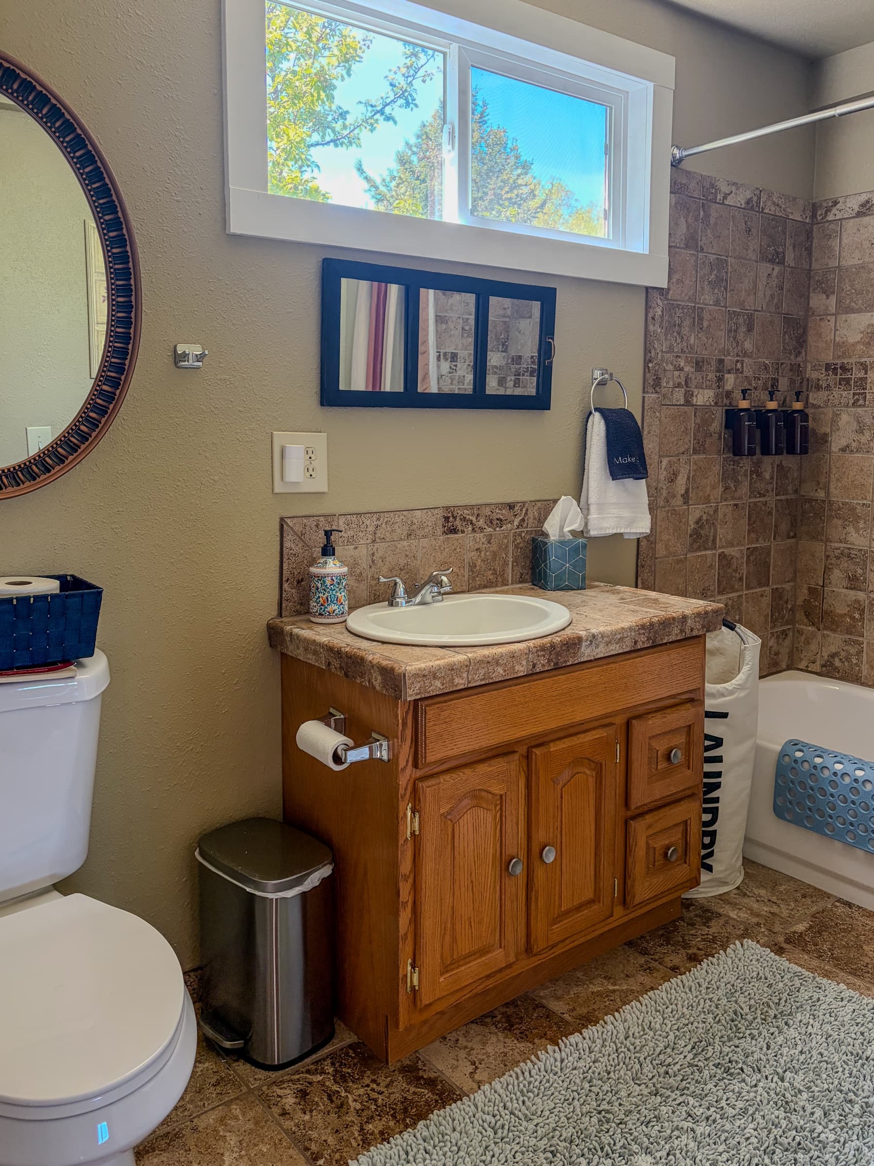Bathroom inside The Cottage with vanity, shower, and natural light